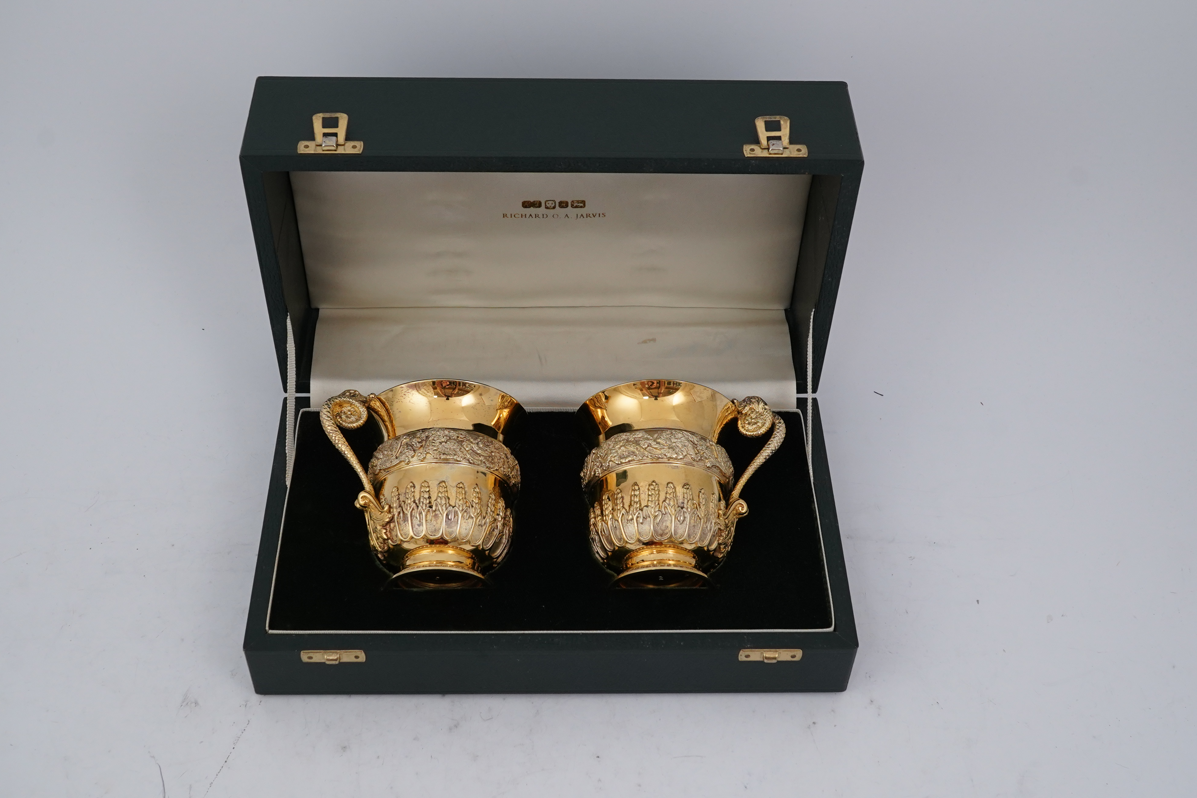 An ornate pair of Elizabeth II silver gilt cups, by Richard O.A. Jarvis